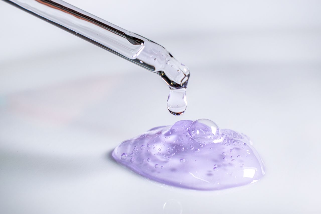 Mastering the First Impression: Your intriguing post title goes here Pipette releasing drop of purple gel, highlighting skincare and laboratory use.