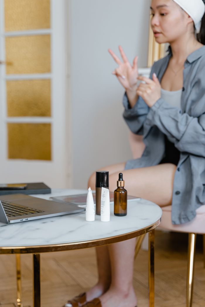 Crafting Captivating Headlines: Your awesome post title goes here A woman applying skincare products in a cozy indoor setting.